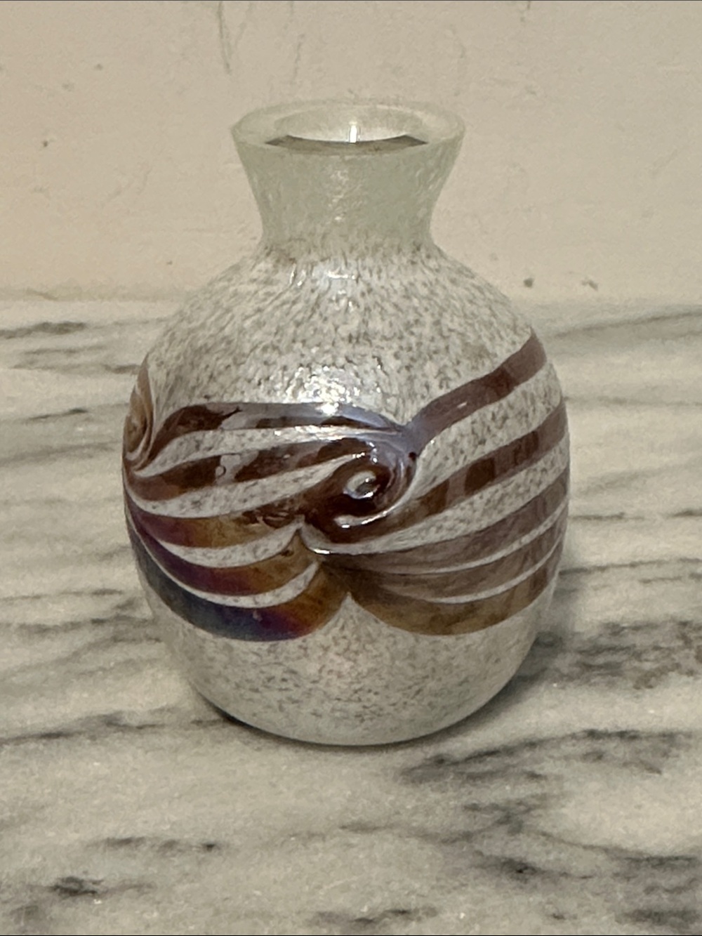 Small iridescent glass vase with purple swirl